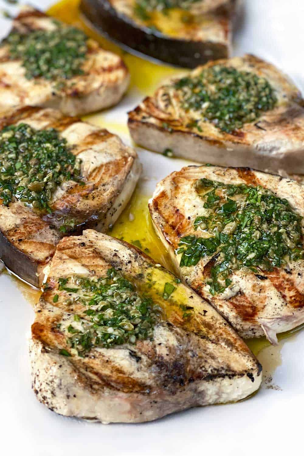 5 grilled swordfish steaks topped with green salsa verde
