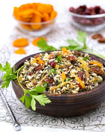 This wild rice salad is bejeweled with cranberries, apricots and pecans and dressed with orange shallot vinaigrette. It's The perfect side dish for Thanksgiving or any festive meal.