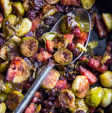 Halved roasted brussels sprouts with thick cut bacon lardons and dried cherries.